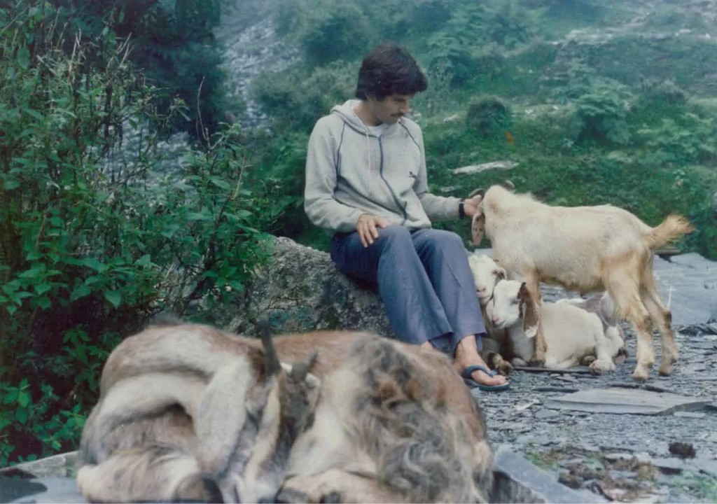 Andrew Cohen as a young man among goats in the Himalayan foothills